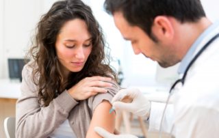 Doctor immunizing a lady